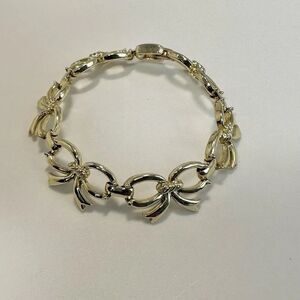 SC gold tone bow bracelet